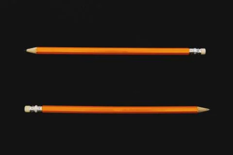 Two pencils on dark surface Stock Photos