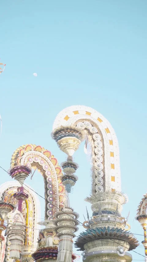 Two Penjor Under Blue Sky with Visible Moon, Gold Tile Detail, Bali Stock Footage 342384275