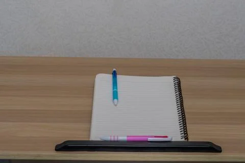 Two pens on a notebook. Stock Photos