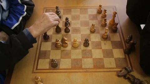 Two pensioners playing chess Stock Footage 75823962