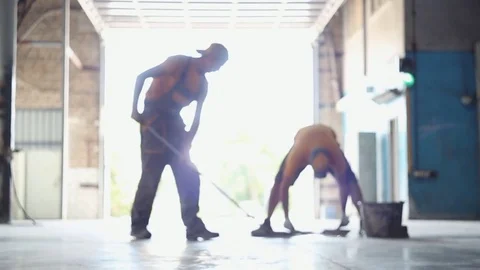 Two people are cleaning construction debris. Establish order in the workplace Stock Footage 79658278