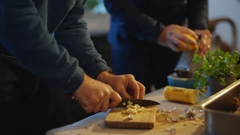 Two people are cutting up a lemon on a table Video stock 295367308