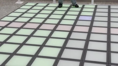 Two people are dancing on a floor with a colorful pattern Vidéo 283486377