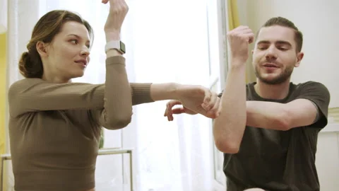 Two people are doing arm exercises Stock Footage 156481086