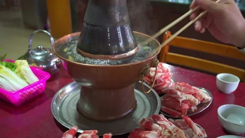 Two people are eating old Beijing hot pot mutton, copper pot shabu-shabu Stock Footage 205582887