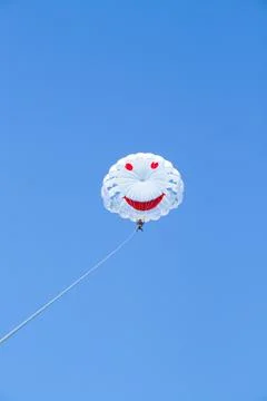 Two people are flying on a white parachute Stock Photos