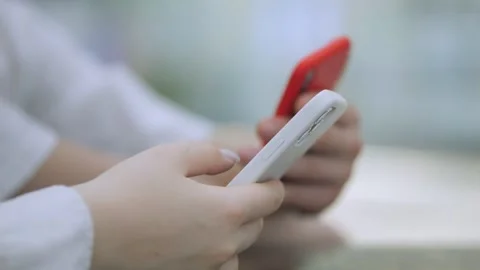 Two people are looking at their cell phones Stock Footage 311326377