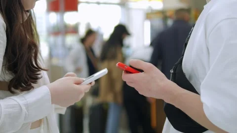 Two people are looking at their phones in a store Stock Footage 311623829