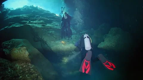 Two people are scuba diving in a cave Stock Footage 299461007