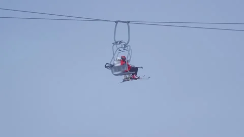 Two People are Sitting on a Ski Gondola 4k Stock Footage 291330744
