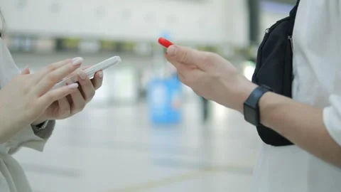 Two people are talking on their cell phones in a public place Video stock 312260358
