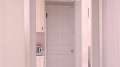 Two people awkwardly avoid each other in a narrow hallway Stock Footage 129340726