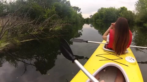 Two people canoeing in the river in slow motion Stock Footage
