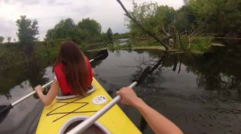 Two people canoeing in the river in slow motion Stock Footage 64233407