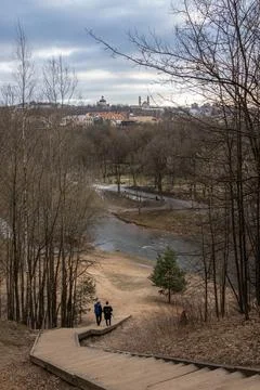 Two people climbing down hill on wooden stairs in Vilnius, Lithuania Stock Photos