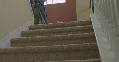 Two people climbing down the steps at home 스톡 동영상 83186825