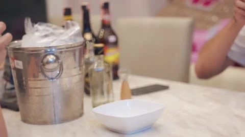 Two people clinking glass drinking alcohol at home Stock Footage 144530356