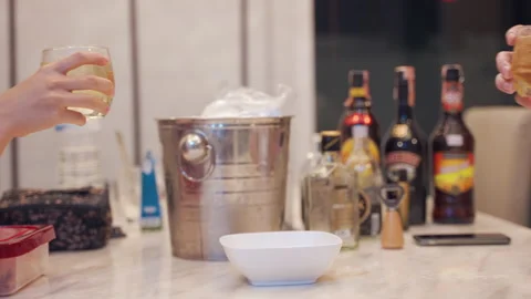 Two people clinking glass drinking alcohol at home Stock Footage 144530472