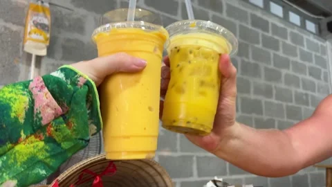 Two people clinking plastic smoothie cups Variety of homemade bubble tea with Stock Footage 316069350
