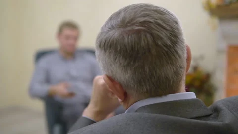 Two people communicate. The man is interviewing. Man with smartphone with Stock Footage 163306414