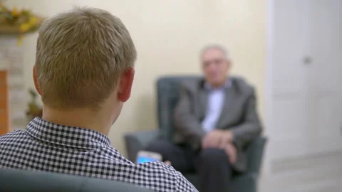 Two people communicate. The man is interviewing. Man with smartphone with Stock Footage 163307250