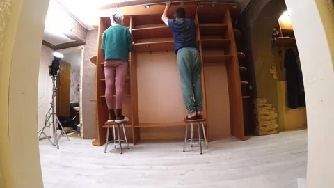Two People Creating Custom Wardrobe With Compartments And Rails Stock Footage 331724100