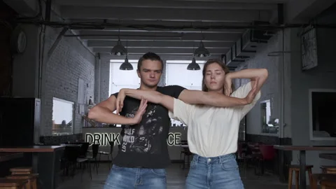 Two people dancing and creating angles with their hands Stock Footage