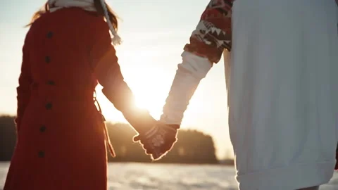 Two people on date during xmas time. Back view of couple holding hands wearing Video stock 144470085