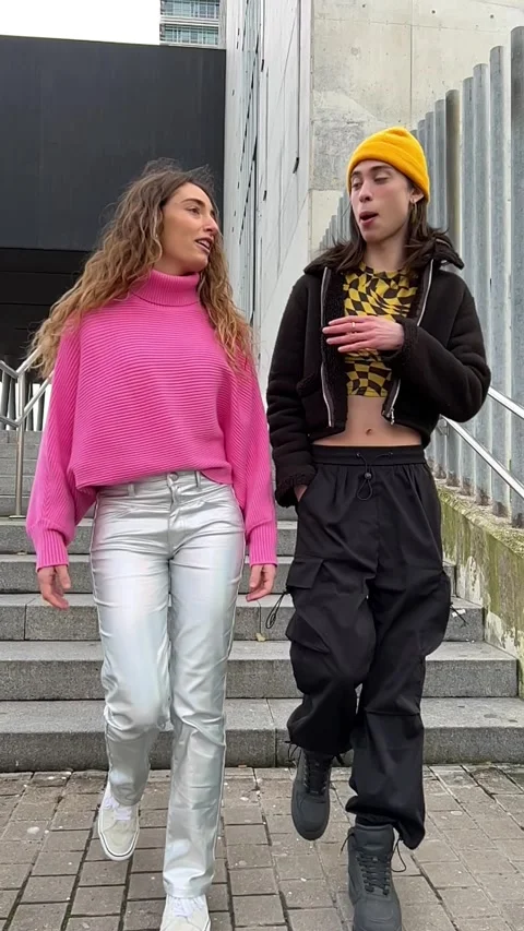 Two people descending a staircase in slow motion while they talk Stock Footage 259853314