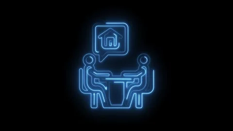 Two people discussing house plans at a table with a neon house icon in a speech Stock Footage 333969301