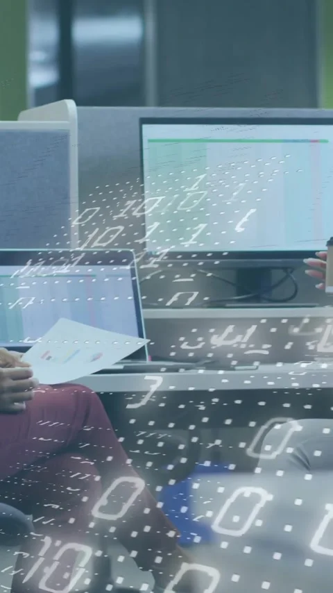 Two people discussing in office with binary code animation overlay Stock Footage 320183820