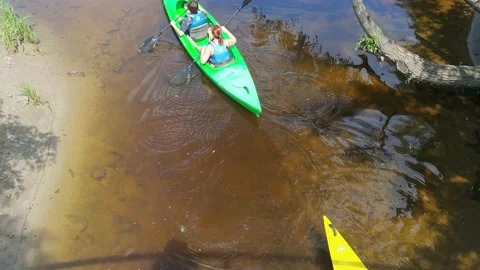 Two people in double canoe or kayak sail along the river Stock Footage 169047902