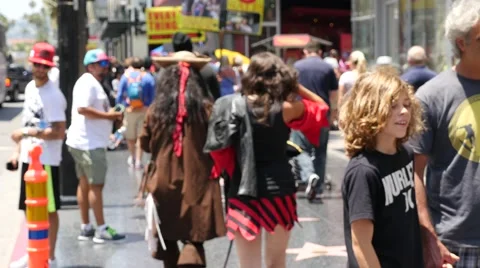 Two people dressed as film's characters walking on the "Hollywood Walk Of Fame" Stock Footage 68909375