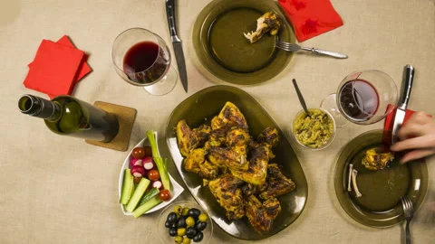 Two people drink red wine while eating   spicy chicken wings,time lapse Stock Footage 86898543