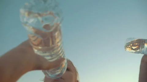 Two People Drinking Water from Plastic Bottles Stock Footage 52073238