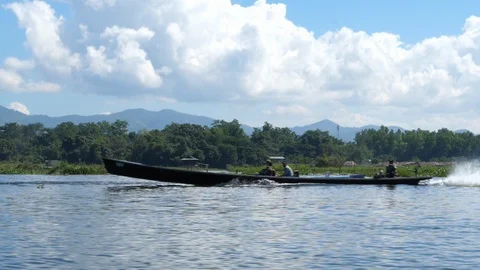 Two people driving a boat on floating burmese gardens, Asia in Hd slow motion Stock Footage 95199240
