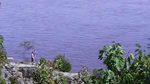 Two People Enjoy River View Along Bluffs Stock Footage 41962585