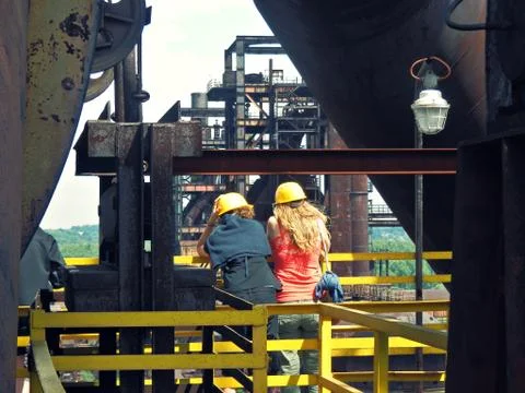 Two people enjoying industrial scene Stock Photos