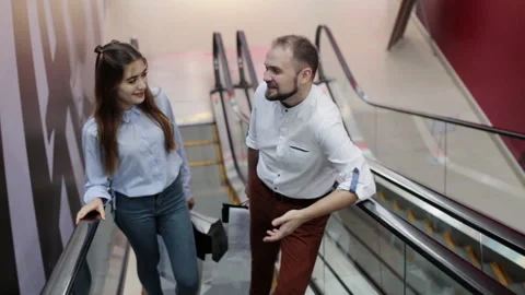 Two people on the escalator in the mall Stock Footage 96706922