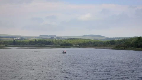 Two People Fishing in a Boat on Vartry R, Stock Video