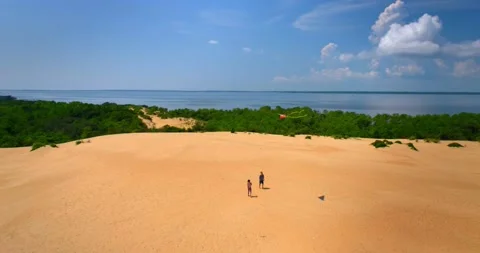 Two People Flying Kites on Outer Banks Sand Dunes, Aerial Drone 4K Stock Footage 141597990