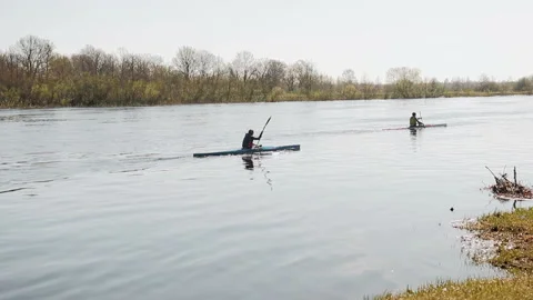 Two people go kayaking down the river Stock Footage 89637297