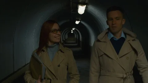Two people going through the tunnel Видео 112038617