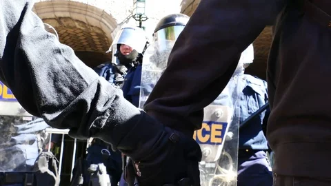 Two people hanging their hand in front of police Stock Footage 95266794
