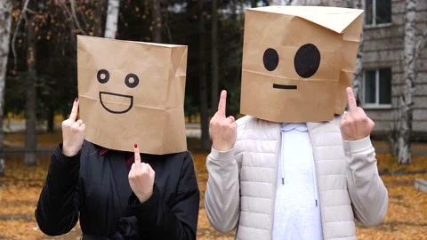 Two people having fun by cover head with paper bags doing obscene gesture Stock Footage 172073180