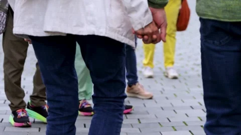 Two people holding hands while walking down the city street, symbolizing lo.. Stock-Footage 287643508