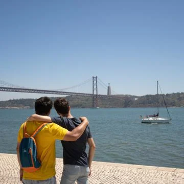 Two people hugging looking over the river Stock Photos
