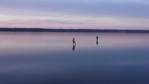 Two people ice skating at sunset. Stock Footage 144250104