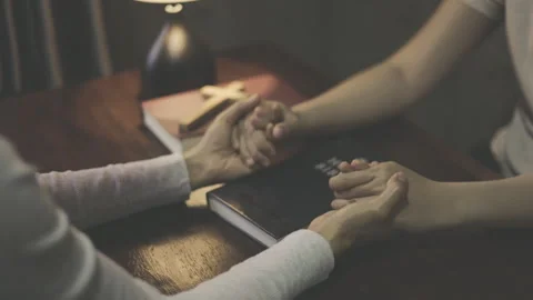 Two people joining hands in prayer, seeking God with faith and hope, symbol.. Stock Footage 340622827