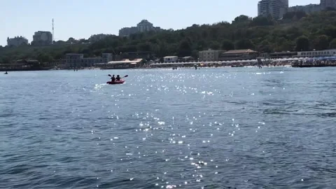 Two people on a kayak on the beach Stock Footage 136109710